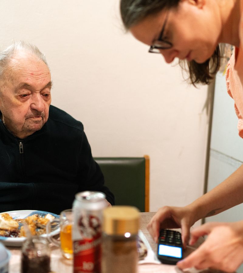 MG Medical Transport caregiver assisting a patient with steady, unhurried support